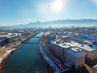 Panorama view of the city Villach in Carinthia, Austria. Big city with beautiful church, ferris wheel, and mountains on the background. Taken in the winter.