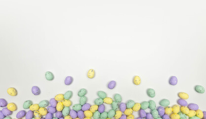 Top view of colourful easter eggs on white background. Creative easter composition, spring, copy space, flat lay.