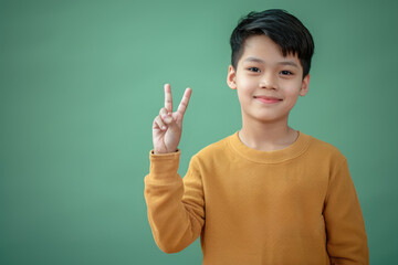 Young boy making peace sign with his hands, suitable for various concepts and designs