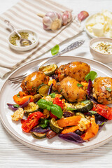 baked chicken thighs with veggies, olives, feta