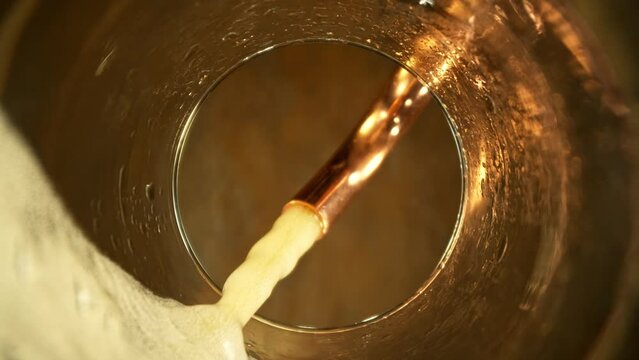 Super Slow Motion of Macro Shot of Pouring Beer drink. Unique Perspective from inside of a Glass. Filmed on High Speed Cinema Camera, 1000 fps. Speed Ramp Effect.