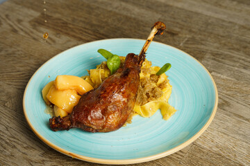 Roasted goose leg with cabbage papardelle pasta and quince compote