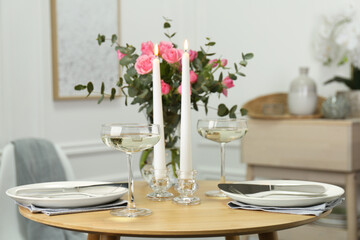 Fototapeta na wymiar Romantic table setting with candles and flowers