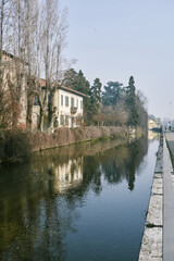 Picturesque scene of Milan's Naviglio Martesana, a peaceful haven amidst the bustling city. - 743767541