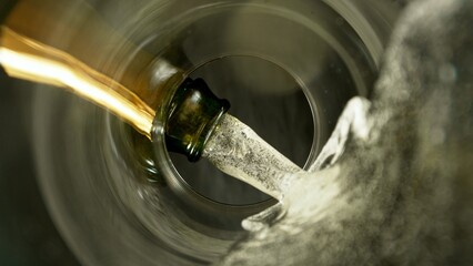 Freeze Motion Shot of Champagne Wine Pouring, Unique Angle of View from the Bottom of the Glass