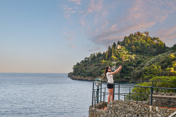 Teenage girl (13 years old) taking a selfie with her smarphone on the Terrace of Punta Caieca...