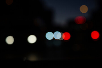 bokeh abstract background of traffic jam in the city at night, headlights of cars selective focus