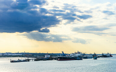 Fototapeta premium Sunset over Gas tankers and refinery Esso Oil Terminal, Southampton, Hampshire, England
