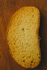Bread crumbs on a wooden board closeup view. Minimalism. Healthy vegan bread choice. Food.