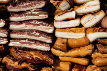 Exposed bacon and dried meat domestic products presented for sale on a farmer's market in Kacarevo village, gastro bacon and dry meat products festival called Slaninijada (bacon festival) held yearly