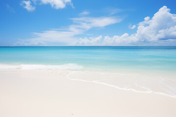 Fototapeta na wymiar White sandy beach with waves at the ocean, clouds