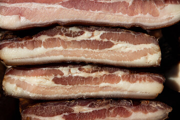 Exposed bacon and dried meat domestic products presented for sale on a farmer's market in Kacarevo village, gastro bacon and dry meat products festival called Slaninijada (bacon festival) held yearly 