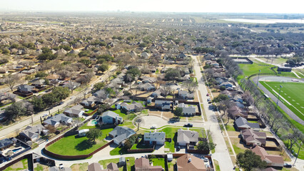 Aerial view upscale residential neighborhood with downtown skyline in distance background, single...