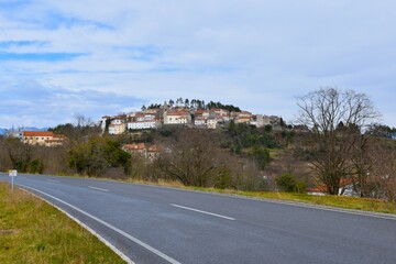 View of historic Stanjel town at Kras, Primorska, Slovenia and a road in front