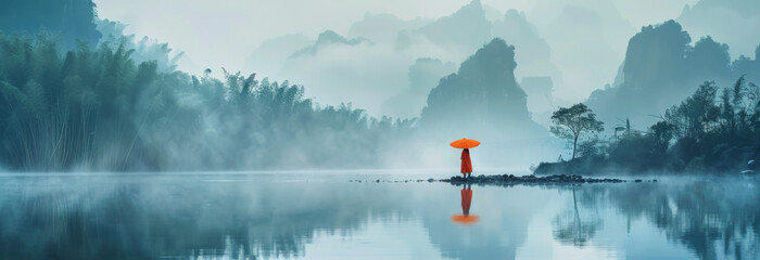 Foggy morning on the lake with red umbrella. panorama
