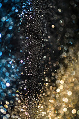 Vertical Glitter vintage lights background. gold, silver, blue and black. de-focused.