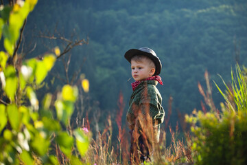 Cute Little Boy with Hat and Bandana in Beautiful Mountains - 743835166