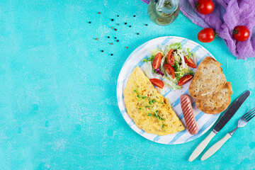 Fried omelette with sausage and salad. Delicious breakfast with eggs and toast