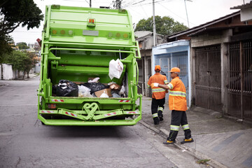 Garbage truck, dirt and people with collection service on street in city for public environment...