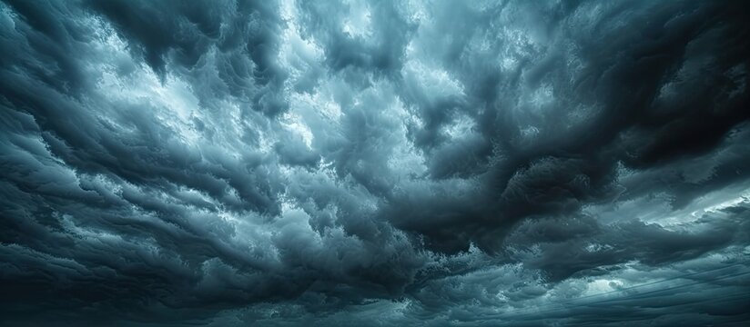 A gloomy and turbulent sky filled with storm clouds dominates the panoramic view.