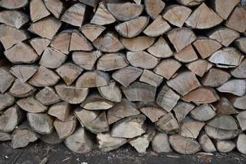 Foto op Plexiglas chopped neatly stacked firewood as background, texture of wooden firewood as background  © Анна Климчук