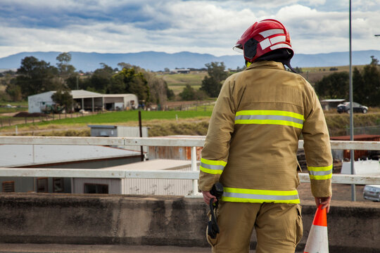 Firefighter setting up road cones for a roadblock