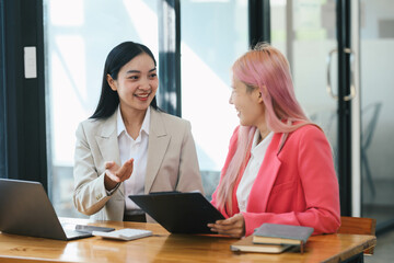 Young smart business people working together in the office, discussing project for the meeting.