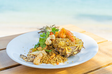 Seafood fried rice in pineapple, appetizing in a cafe next to the sea, Sue Flamingo, Ao Yon Beach, Phuket Thailand
