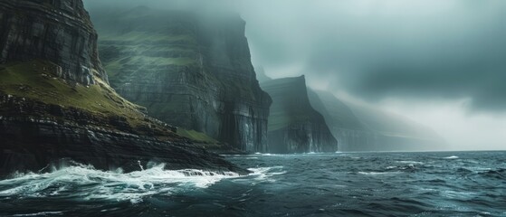 The rugged beauty of the Faroe Islands, Denmark, where dramatic cliffs plunge into the swirling...
