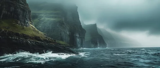 Foto op Canvas The rugged beauty of the Faroe Islands, Denmark, where dramatic cliffs plunge into the swirling waters of the North Atlantic © Artem