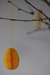 Easter Decoration. Green, yellow and white paper eggs hanging from beautiful naturally thin branches from birch. In Sweden it is often used as an Easter decoration.