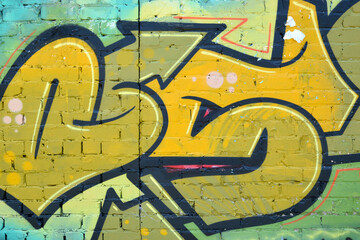 Colorful background of graffiti painting artwork with bright aerosol outlines on wall. Old school street art piece made with aerosol spray paint cans. Contemporary youth culture backdrop