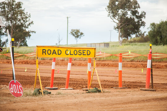 Road closed and stop sign beside roadworks