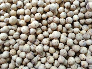 A full-frame photo of a pile of langsat (duku) fruit suitable for a fruit-themed or market-themed background