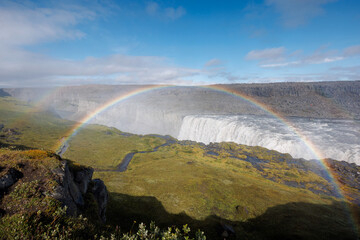 Majestic rainbow over Dettifoss waterfall in Iceland, the second most powerful waterfall in Europe, on a spring day