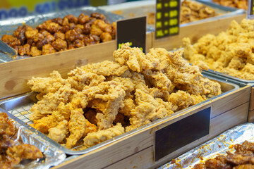 Trays of Golden Fried Chicken at a Food Market