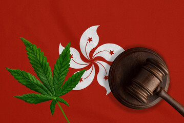 Justice wooden gavel with cannabis leaf on the Flag of Hong Kong. Illegal growth of cannabis plant...