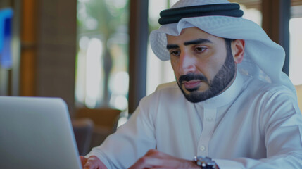 Arabic businessman sitting and working online with laptop