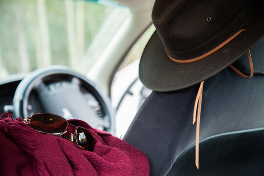 Sunnies and blanket and hat in the back of a car