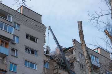 Fototapeta na wymiar An attack drone (shahed) hit the roof of a house. Rocket attack on a residential building in the city of Dnepr. Consequences after a strong explosion. War in Ukraine and Russia. People under the rubbl