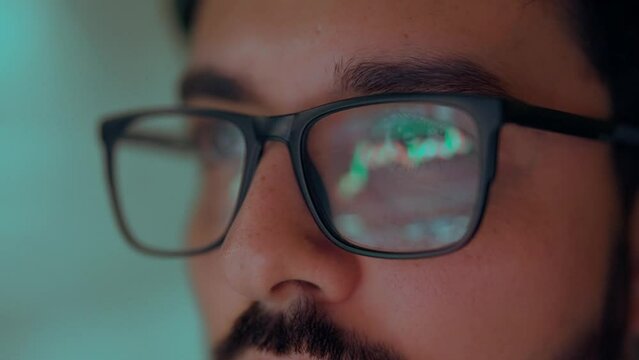 Business man trader broker analyst investor analyzing stock exchange trade crypto financial market looking at computer screen wearing glasses with stockmarket digital chart reflection, close up view.