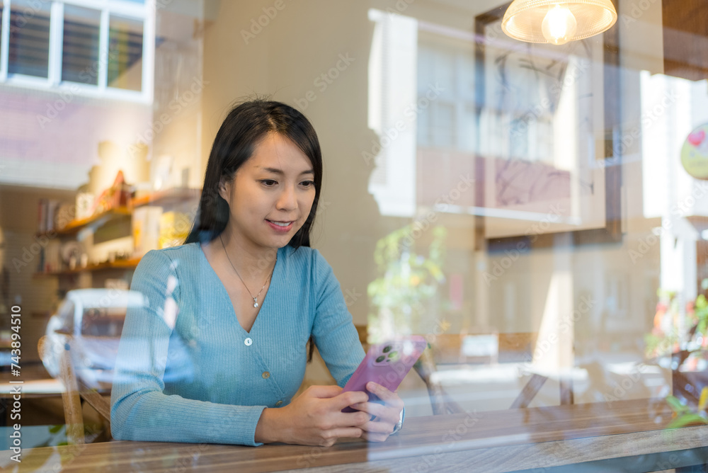 Poster Woman look at smart phone in cafe