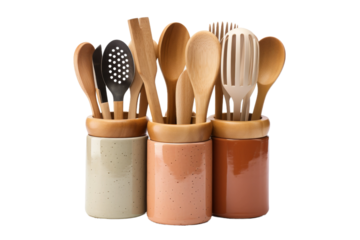 Group of Wooden Utensils in a Jar. A collection of various wooden utensils, including spoons, spatulas, and tongs, neatly arranged inside a glass jar.