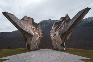 Concrete World War 2 monument with mountain and forest in background, Tjentiste, Bosnia and Hercegovina