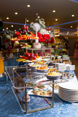 Assorted fruits and snacks on a stylish buffet table at an elegant event.