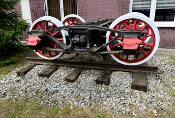 An old undercarriage of a steam locomotive on a fragment of a rail