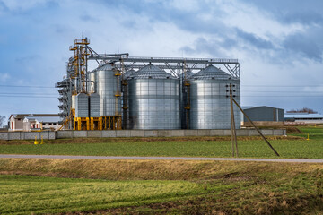Fototapeta na wymiar silos on agro-industrial complex with seed cleaning and drying line for grain storage