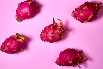 Red dragon fruit Set with appetizing serving on pink background. Top view