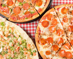 three pizzas on table shot from above