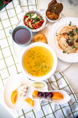 top view Uzbek Food with Tea and Traditional Uzbek Bread on Checkered Tablecloth